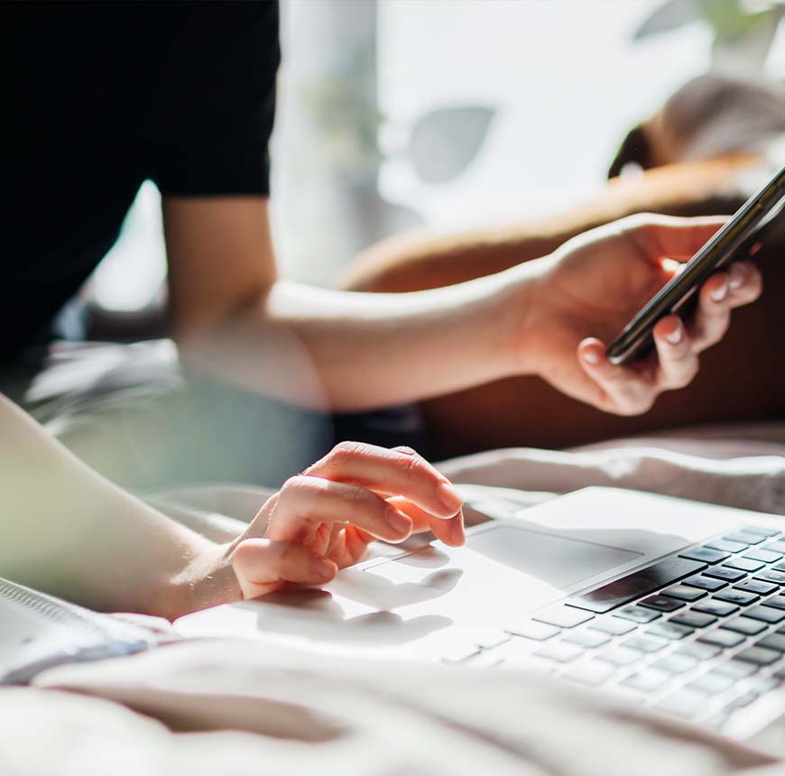 woman using computer and phone